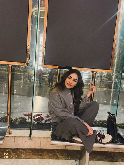 A cozy winter evening look featuring a grey bomber jacket and matching wide-leg trousers. Monochrome dressing is always a chic choice.