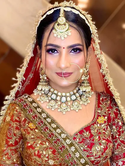 A direct and confident look from the bride. The makeup highlights her sharp features and beautiful eyes.