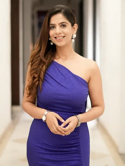 A close-up in my blue evening gown. The simple accessories and wavy hair complete the look.