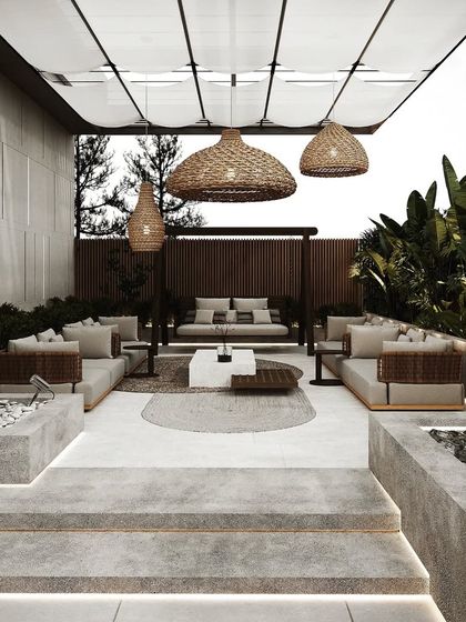 Another view of the bohemian-inspired rooftop, showing the layered textures of the wicker lights, the fabric canopy, and the lush greenery.