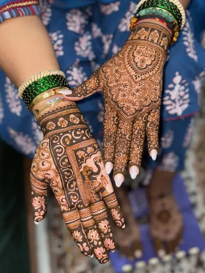 A unique design combining a traditional, dense pattern on one hand with a modern, structured design on the other, featuring a peacock motif.