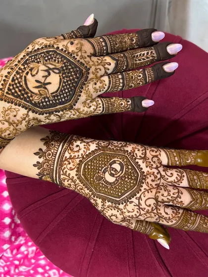 A side view of the engagement design, highlighting the details on the fingers and the hexagonal centerpiece.