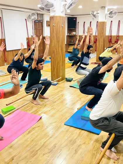 Using a simple stick or dowel can greatly improve alignment and shoulder mobility in poses like Utkatasana (Chair Pose). It helps keep the arms active and the chest open.