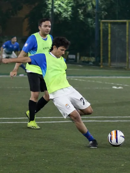 A player lines up a powerful shot on goal during a training match. We focus on improving fundamental skills like shooting, passing, and positioning.