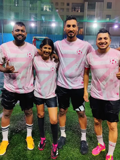 Our coaching team in their pink jerseys, standing together after a rainy session. A team that trains together, wins together.