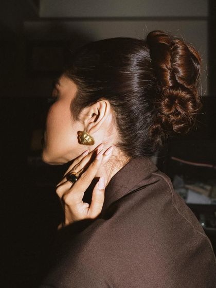 A detail shot focusing on Malavika Mohanan's elegant updo and jewelry. Sometimes the most compelling portraits are the ones that hint at a larger story.