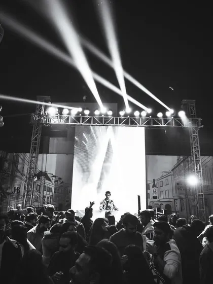 A black and white shot of an outdoor performance in Delhi. The stage, lighting, and packed audience demonstrate my ability to command a large open-air venue.