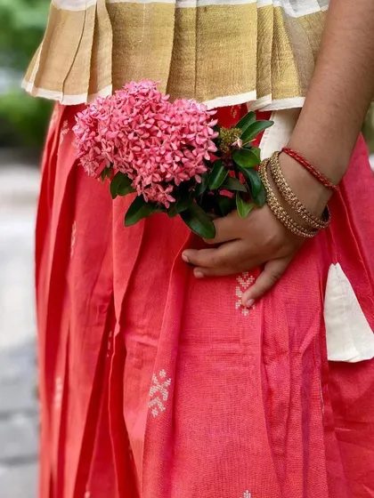 The beauty is in the details. This close-up of my Nila set shows the delicate Jamdani motifs on the peach cotton skirt and the traditional Kasavu border on the peplum top. It’s a celebration of Indian handloom craft.