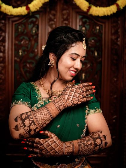 Another lovely portrait of the bride, her happiness radiating as she displays her mehendi.