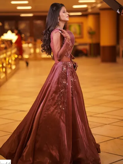 A side profile of the bride, highlighting the flow of her gown and her elegant posture.