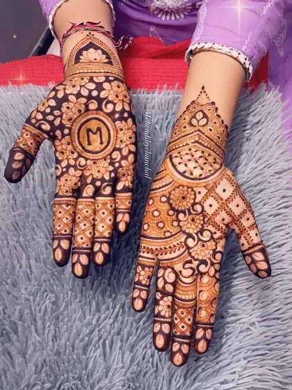 A festive design for Diwali, with the initial 'M' in a central mandala, surrounded by floral patterns.