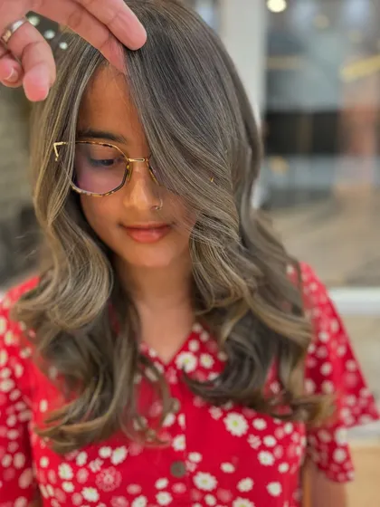 Ash blond hair with perfect face framing. This look is trendy but requires proper aftercare to maintain its cool tone.