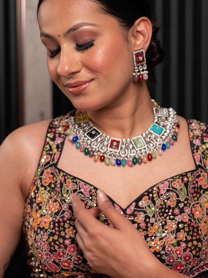 A close-up of the unique jewellery paired with our multi-colored lehenga. We offer a range of accessories to perfectly complement your chosen outfit.