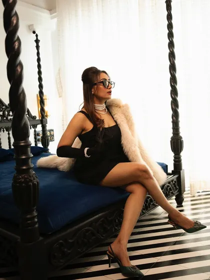 A full-length shot from the 90s-themed editorial. The voluminous puff hairstyle adds a touch of drama and completes the retro-glam aesthetic of the entire look.