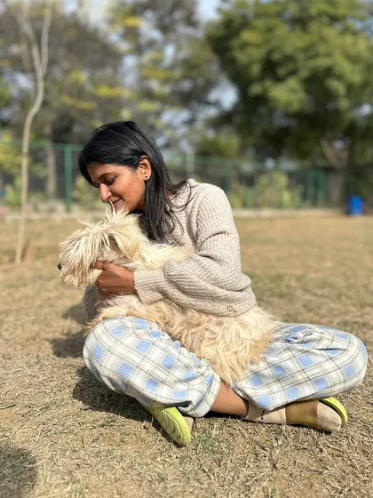 A gentle cuddle with a fluffy companion. This quiet moment reflects the soft, nurturing side of our work. It's about providing comfort and affection in a way that the animal understands and accepts.