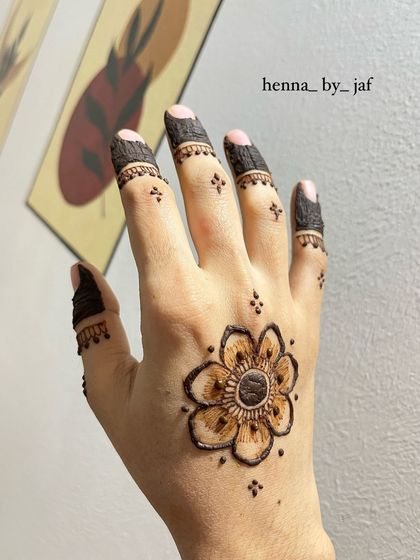 A simple single flower motif on the back of the hand, which I did on myself with my non-dominant hand.