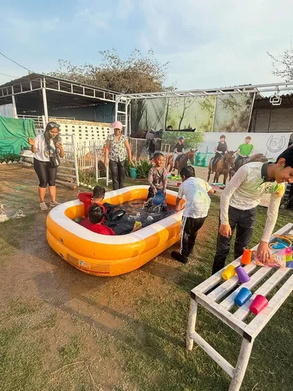 An overview of the fun zone during Holi, with kids and adults enjoying the pool and festive atmosphere.