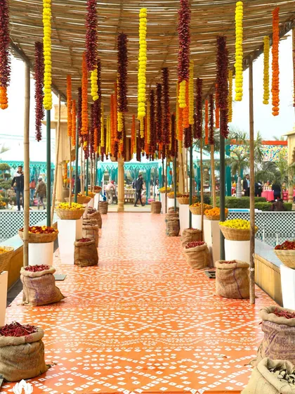 The entrance to a "Spice Market" themed Mehendi, with hanging garlands of marigolds and red chillies. This unique theme was carried through every detail of the decor.