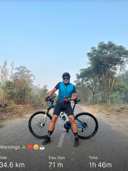 A member posing with his bike after a 34km ride. The satisfaction of a good ride is written all over his face.