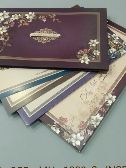 This invitation set comes in a deep purple color with a delicate floral border. The design is rich and sophisticated, with multiple inserts for your event details.