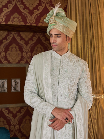 The complete light green sherwani ensemble, with a matching stole and safa. This pastel shade is perfect for a destination or summer wedding, offering a cool yet regal alternative.