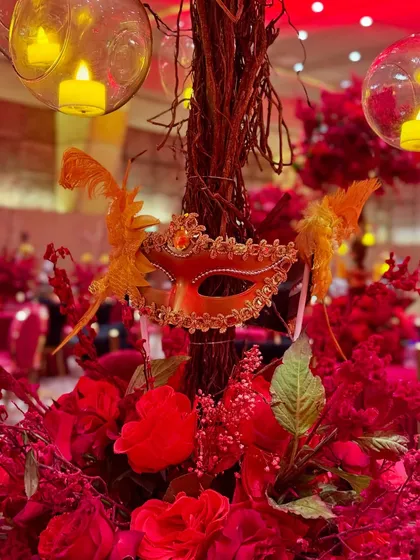 This masquerade-themed party was drenched in dramatic red lighting, with intricate floral centerpieces, candelabras, and even a mirrored mannequin adding to the mysterious and glamorous vibe.