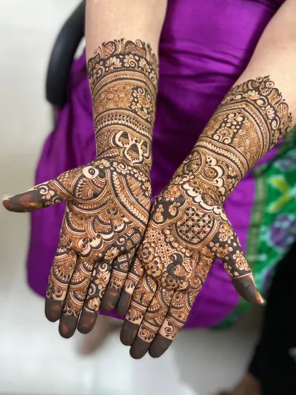 A rich and detailed design perfect for a bride, combining peacocks, paisleys, and floral elements in a dense, beautiful pattern.