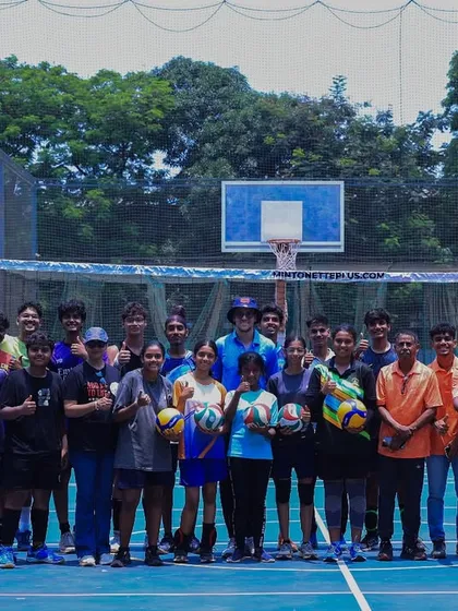 The Mintonette+ family, a mix of players and coaches, posing for a group photo on the court. We are a diverse community united by volleyball.