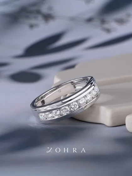 A piece that reflects your journey and strength. This channel-set diamond ring in white gold is more than an accessory; it is a testament to your story. Every facet captures a moment that defines you, for memories that endure and milestones that last.