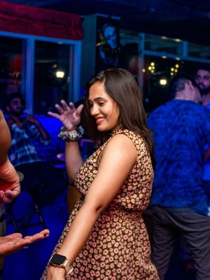 A guest smiling as she dances. The positive energy is what makes my pub special.
