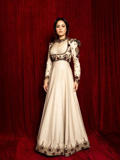 A full-length static pose, emphasizing the grandeur and elegance of the traditional couture.