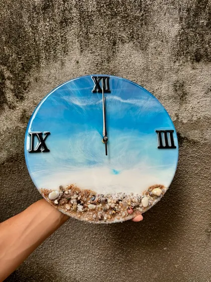 Here’s one of my most popular creations, the ocean-themed resin wall clock. I use real sand and shells to create a miniature beach scene, and the layered resin waves give it a realistic 3D look. It's a beautiful piece of functional art for any home.