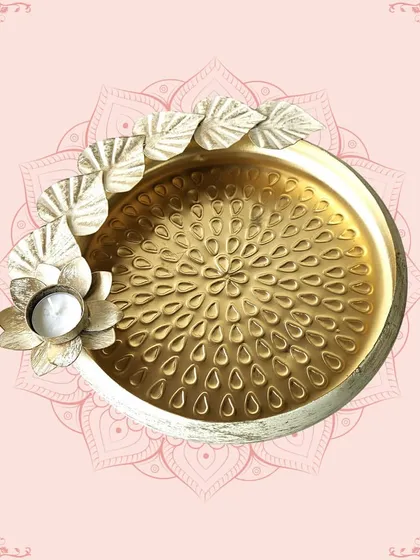A golden platter with a distressed white finish and a floral T-light holder. This versatile piece is perfect for serving or as a decorative centerpiece.