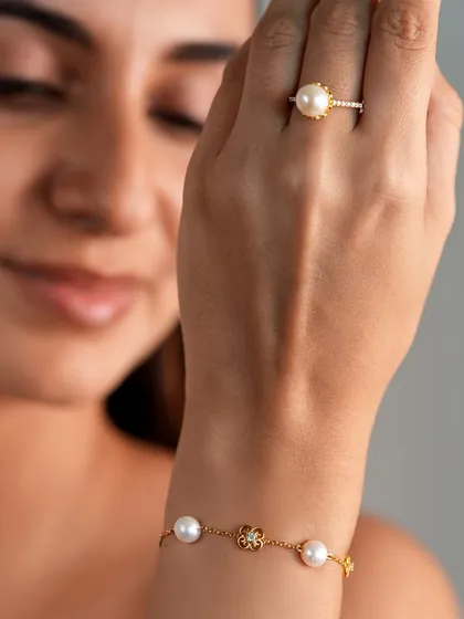 A piece for someone special, or just for you. This model shot shows the delicate elegance of the pearl bracelet and matching ring, perfect for both special moments and everyday wear.