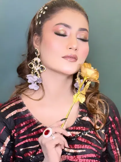 Eyes closed to show the detail of the glittery gold and bronze eyeshadow from this creative look.