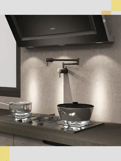 This detailed view highlights the functionality of the cooking area, with a modern hob and a convenient pot-filler faucet mounted on the textured backsplash.