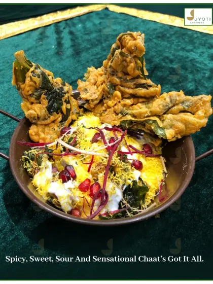 A sensational Palak Patta Chaat. Crispy spinach leaves are fried and topped with yogurt, chutneys, and pomegranate seeds for a perfect blend of spicy, sweet, and sour flavors.