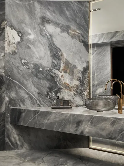 The powder bathroom in Project Acropolis makes a bold statement with dramatic grey marble. We used a single, powerful material to create a space that feels both luxurious and immersive, featuring a custom cantilevered vanity and a striking crystal-cut glass basin.
