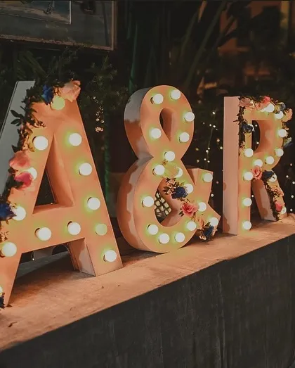 A classic way to personalize your event. I decorated these large, light-up marquee letters of the couple's initials with delicate flowers, creating a perfect photo-op and branding for the wedding.