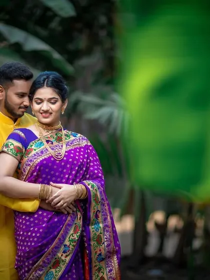 A romantic pre-wedding portrait of a couple in a lush, green setting, capturing a quiet moment of togetherness.