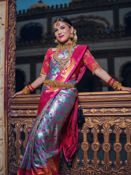 A full-length view of the multi-colored saree, showing its regal drape and how the makeup completes the look.