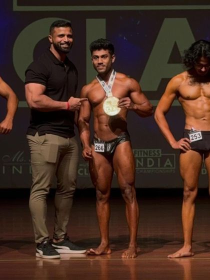 On stage with the judges at Muscle Mania. My client earned his spot as a top competitor in the classic physique division.