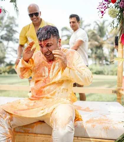 The aftermath of a messy but fun Haldi, with the groom covered in a mix of ingredients.