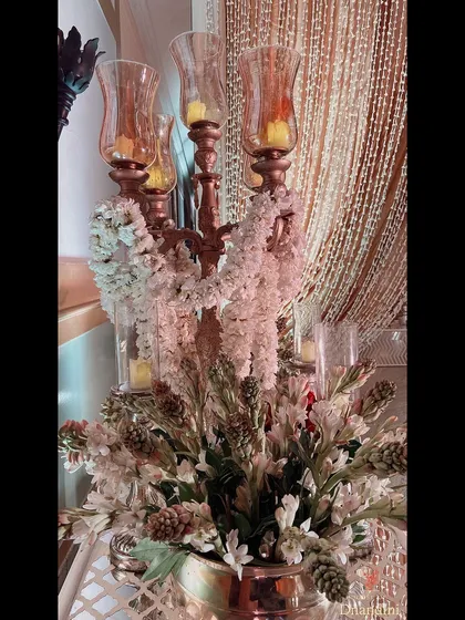 A close-up of a floral arrangement featuring tuberoses, whose beautiful scent filled the sangeet ballroom. The candelabra is draped with a delicate string of tuberoses.