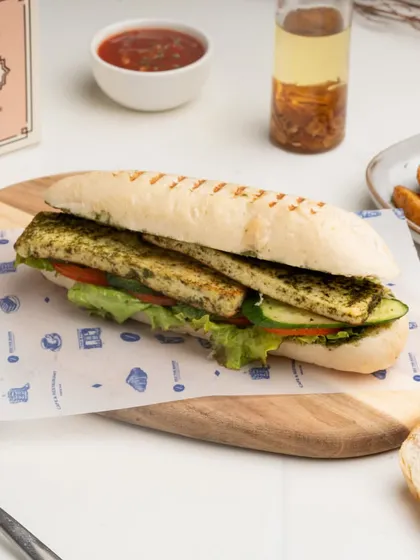 A closer look at the layers inside my Grilled Paneer Panini, showcasing the pesto-marinated paneer and crisp vegetables.