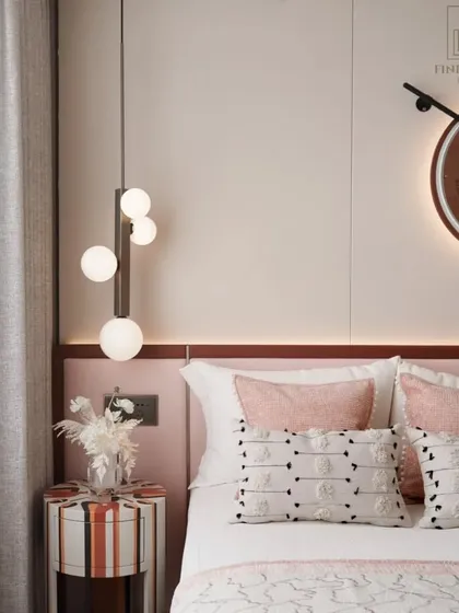 A close-up of the bedside, with a modern cascading globe pendant light and a unique striped side table. These details add a playful yet chic touch to the room's overall music-inspired theme.
