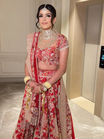 A complete bridal look, ready for the ceremony. The soft waves in her hair add a touch of modern romance to the traditional attire.