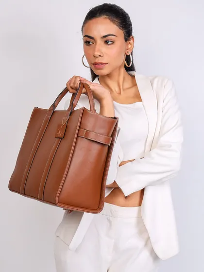 A classic lookbook-style shot for the fashion brand Yuvastree. This image highlights the handbag's design and quality while showing how it complements a professional and chic outfit, perfect for e-commerce listings.