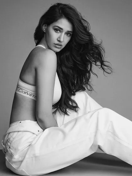 Another powerful black and white shot from the Calvin Klein campaign with Disha Patani. The combination of the tousled, voluminous hair and the clean makeup creates a look of effortless confidence.