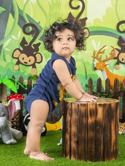 This curious infant is exploring his jungle surroundings, standing tall by a log. A great shot for capturing those early standing moments.